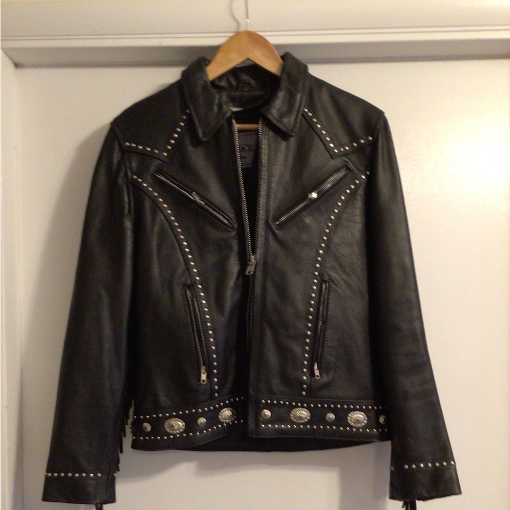 Black leather riding jacket fringed with conchos